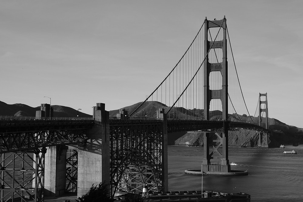 Black and white landscape photo of one of the golden gate bridge.