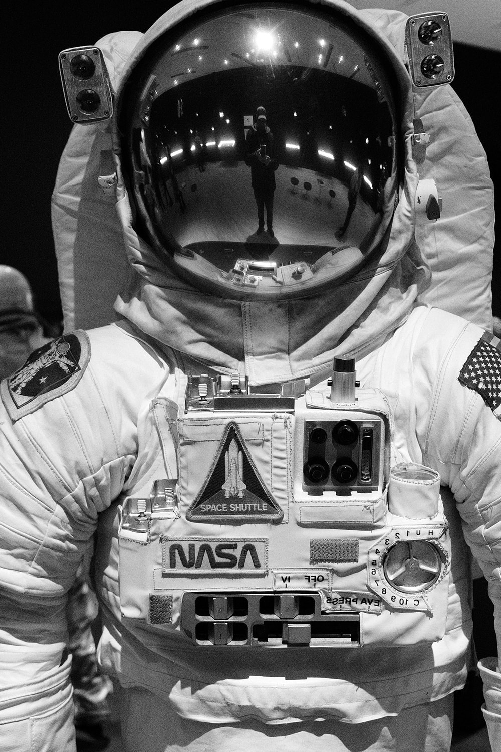 Black and white portrait photo of a NASA space suit on display at the San Francisco Museum of Modern Art.